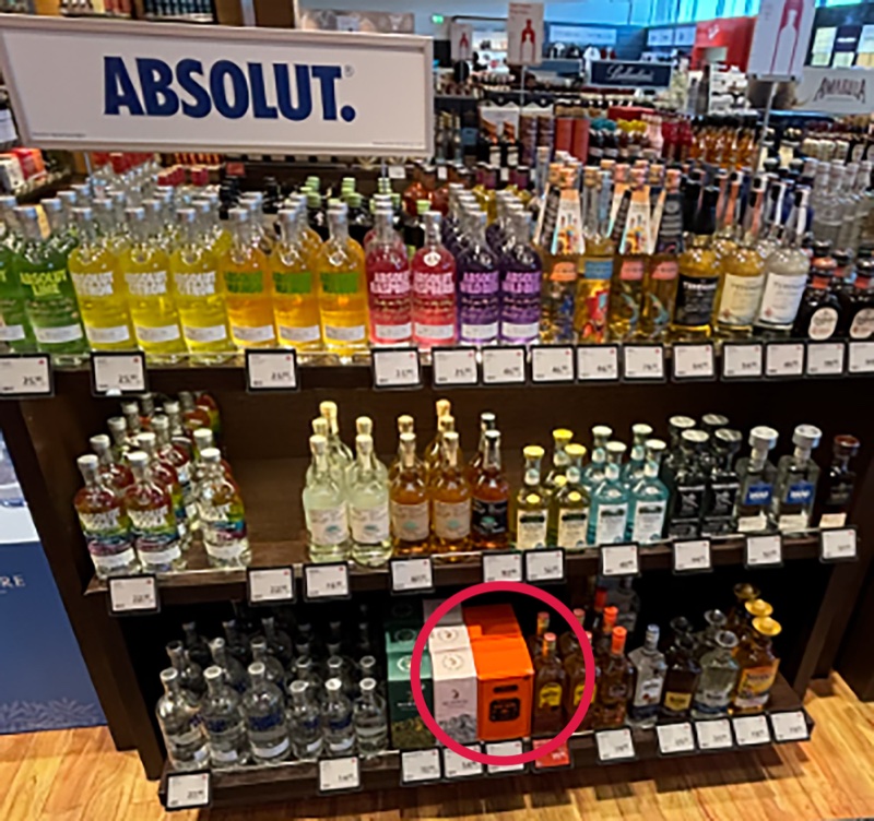 The audited spirits fixture in Frankfurt T2, with Patrón circled on the bottom shelf, dwarfed by the surrounding range